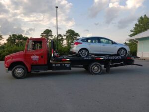 All Star Towing truck hauling a vehicle
