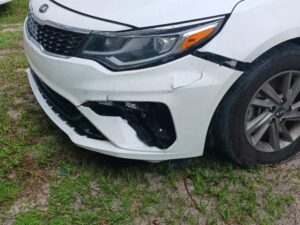 White Vehicle with damage to the front left panel