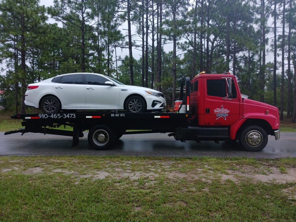 All Star Towing, company truck hauling a white vehicle