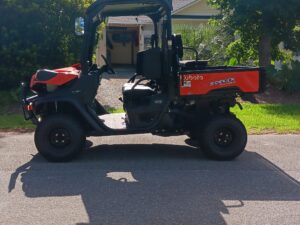 A damaged golf cart ready to be hauled by All Star Towing