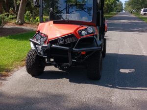 A damaged golf cart ready to be hauled by All Star Towing