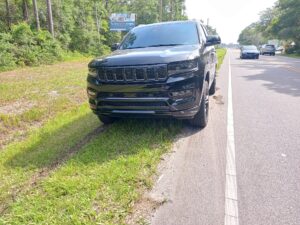 Black vehicle on the side of the road